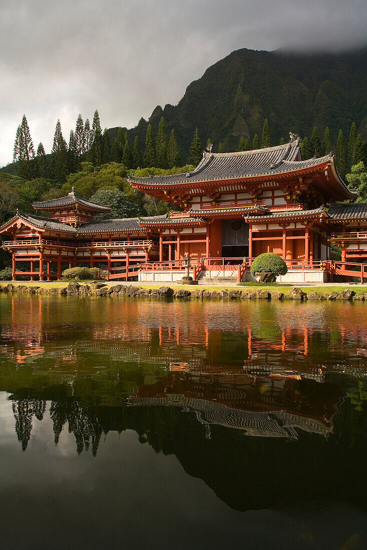 Hawaii, Oahu, Ahuimanu Valley, Valley of the Temples, Byodo-In Temple and reflection in pond, Mountains in background.
