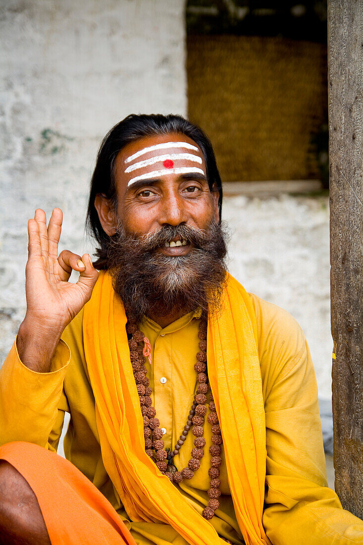 Nepal, Kathmandu, religious man at Pashupatinath holy Hindu place on Bagmati River, painted and colorfully dressed.