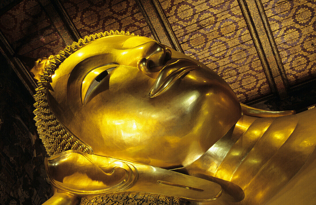 Thailand, Bangkok, Wat Po Close-up of gold Reclining Buddha head