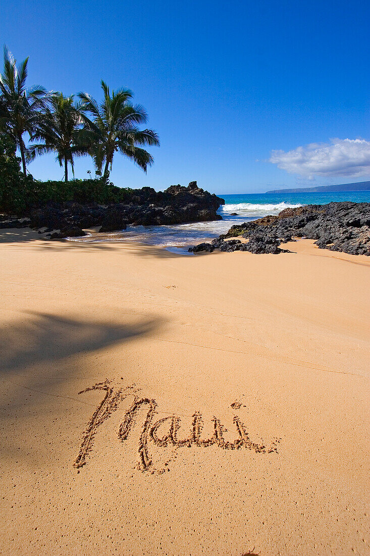 Hawaii, Maui, Makena, Secret Beach, the word Maui written in the sand.