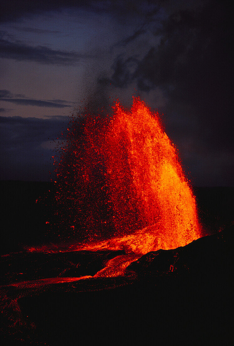 Hawaii, Big Island, Kilauea Volcano fountaining at 700 feet, red lava in the night sky.