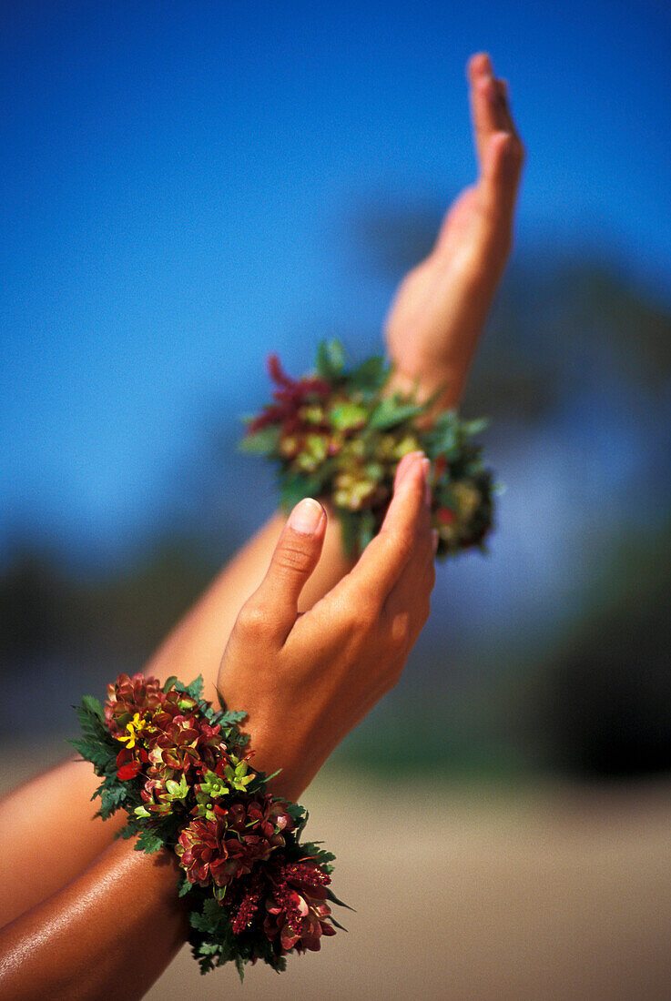 Close-up of hula hands with flower bracelets