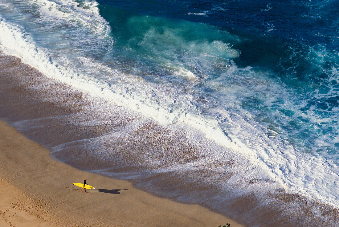 Hawaii, Oahu, North Shore, Waimea Bay, winter surf, surfer walking, foamy waves