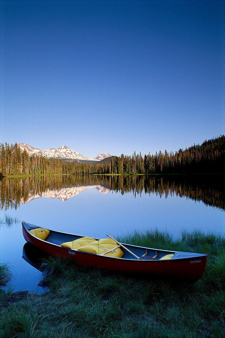 Oregon, Cascade mountains, Canoe at Scott Lake, Three Sisters mountain reflections background B1657