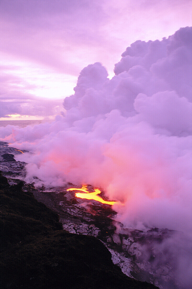 Hawaii, Big Island, Hawaii Volcanoes National Park, lava entering ocean at dawn, purple smoke billows C1632