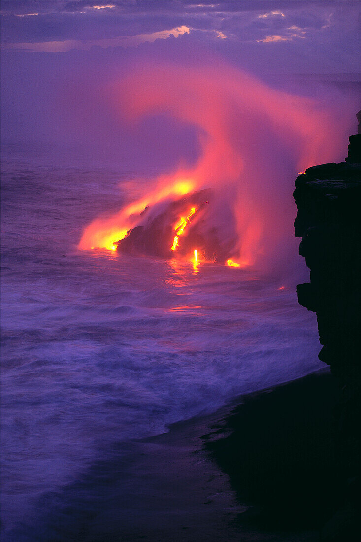 Hawaii, Big Island, Kilauea Volcano, lava meets ocean action, glowing in pink steamy skies