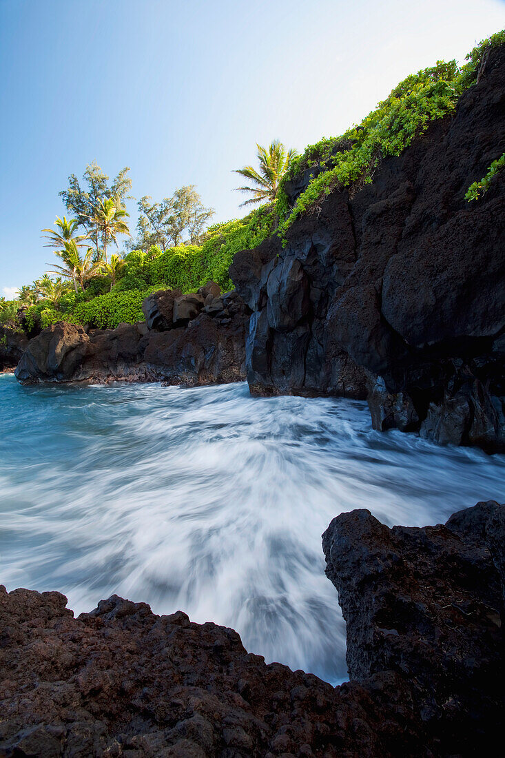 Hawaii, Maui, Hana, The rocky coastline of Waianapanapa showing the movement of the water.