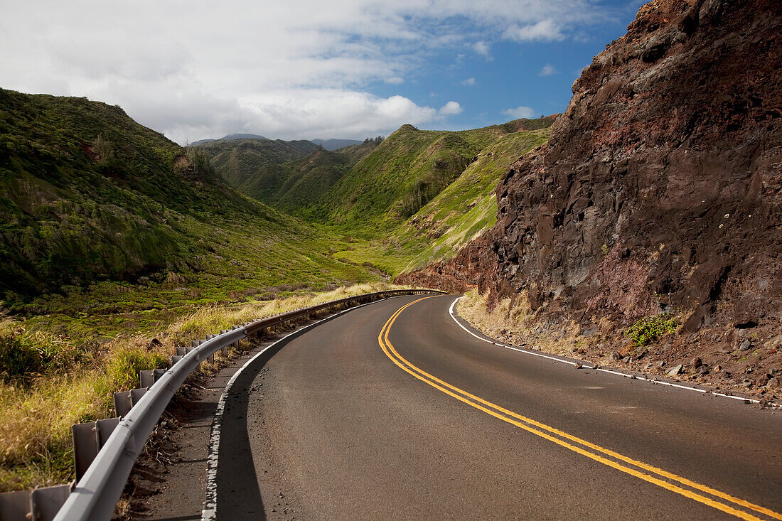 Hawaii, Maui, A winding road through Maui's west side with lush mountains.