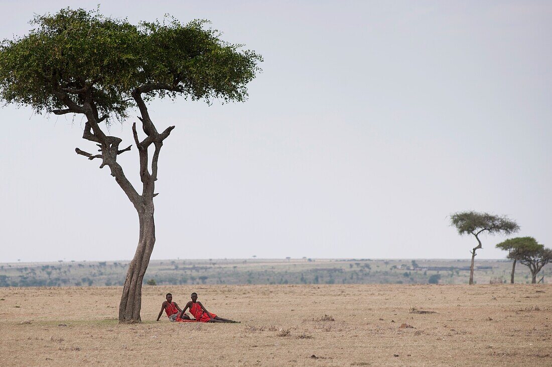'Two Men Sitting On The Plain; Kenya, Africa'