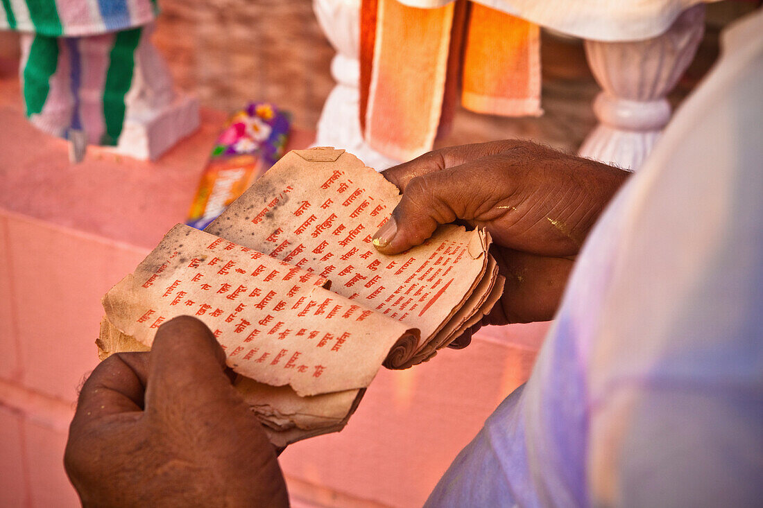 'A Man Holds Paper With Red Text Reading In Worship; Haridwar India'