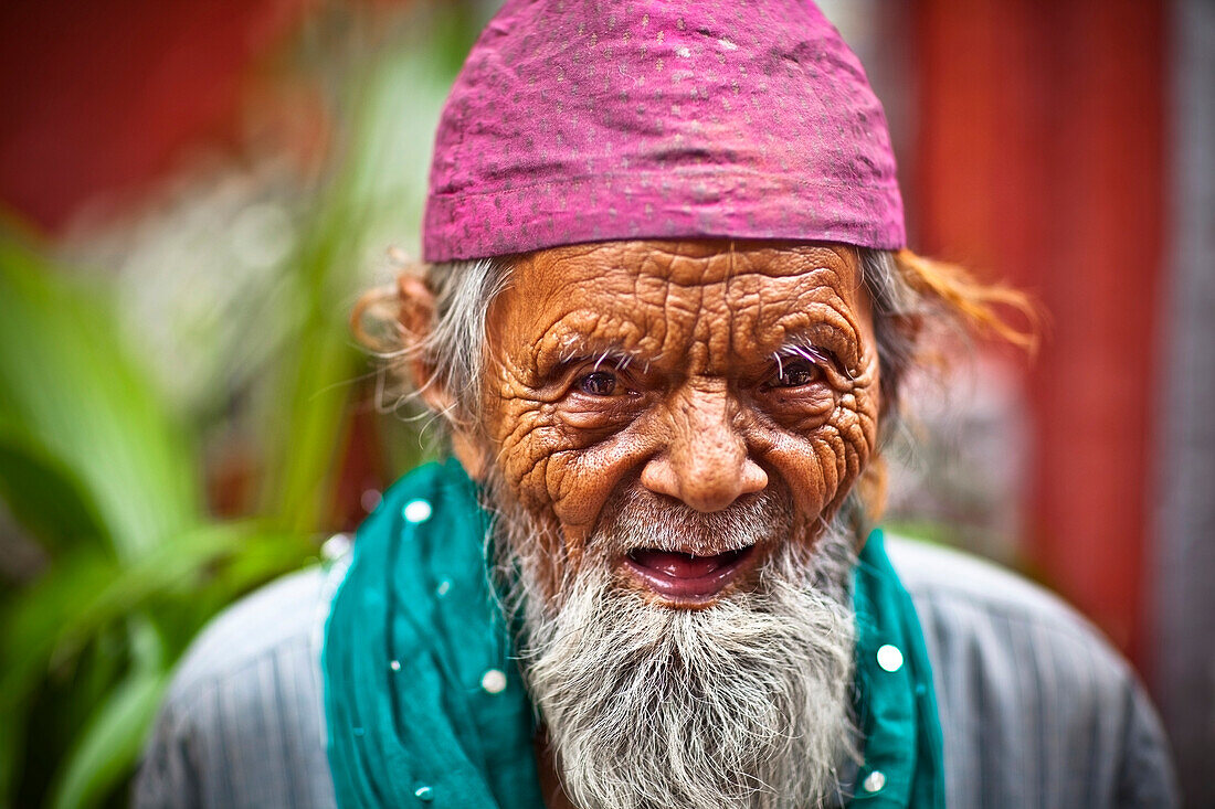 'An Elderly Muslim Man Wearing A Pink Prayer Cap; India'