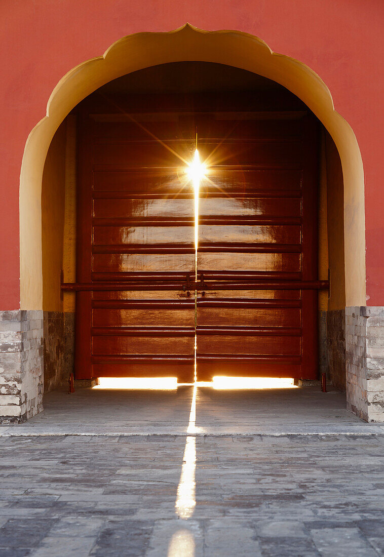 Light streams through a door at the Temple of Heaven in Beijing, China., Beijing, China. Temple of Heaven