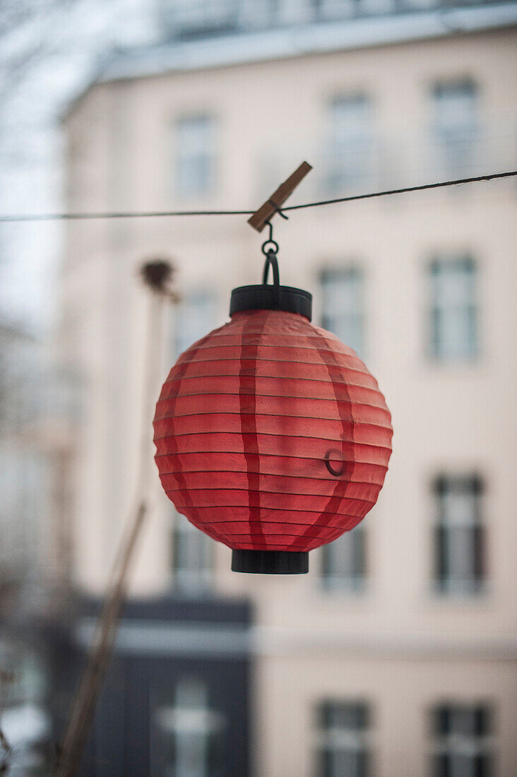 Red paper lampion hung up, Berlin, Germany