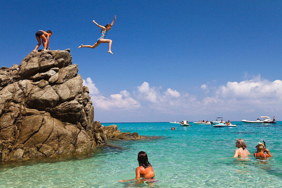 Children jumping off rocks into the sea, Marinella beach, Marina di Zambrone, Tyrrhenian Sea, Calabria, Mediterranean, Southern Italy, Europe