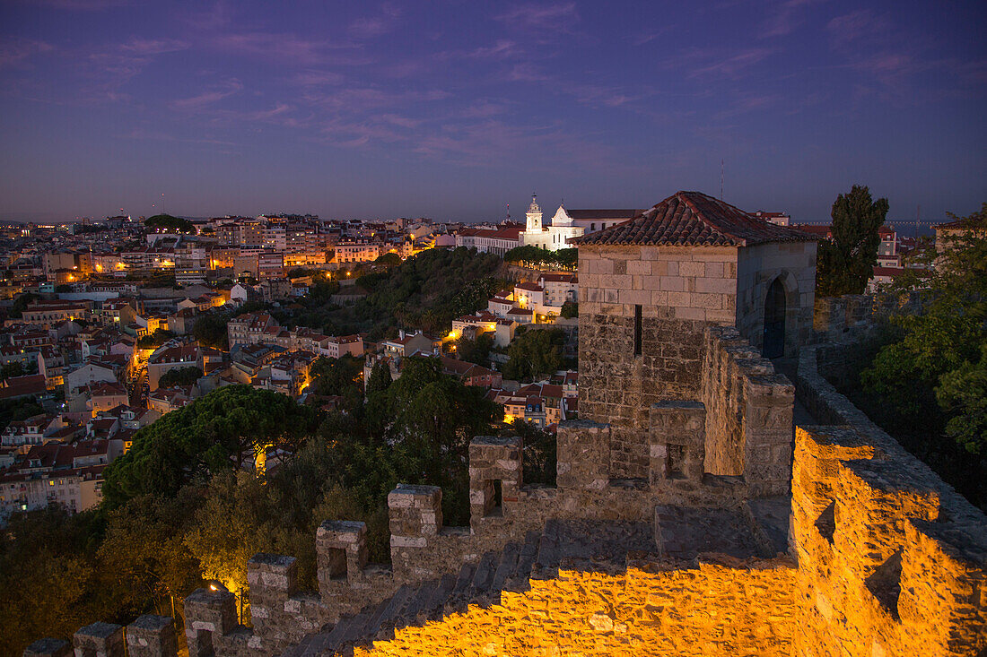 Abenddämmerung am Castelo de San Jorge in der Alfama mit Kirche Igreja da Graca im Hintergrund, Lissabon, Portugal