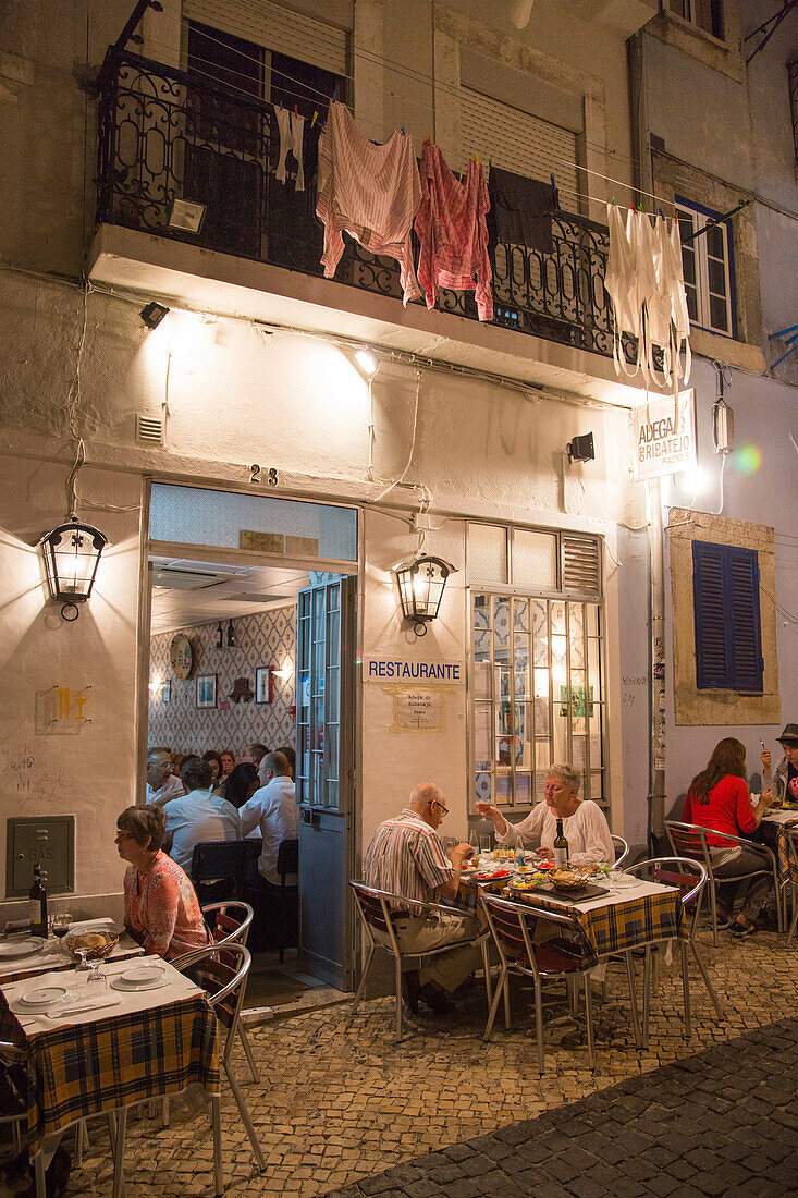 People sitting outdoors and enjoying dinner at Adega do Ribatejo in Bairro Alto district, Lisbon, Lisboa, Portugal