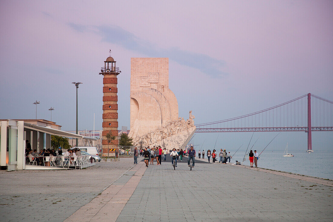 Das Padrao dos Descobrimentos, Denkmal zu Ehren der portugiesischen Entdecker in Belem und die Brücke Ponte 25 de Abril über den Fluss Tejo bei Sonnenuntergang, Lissabon, Portugal