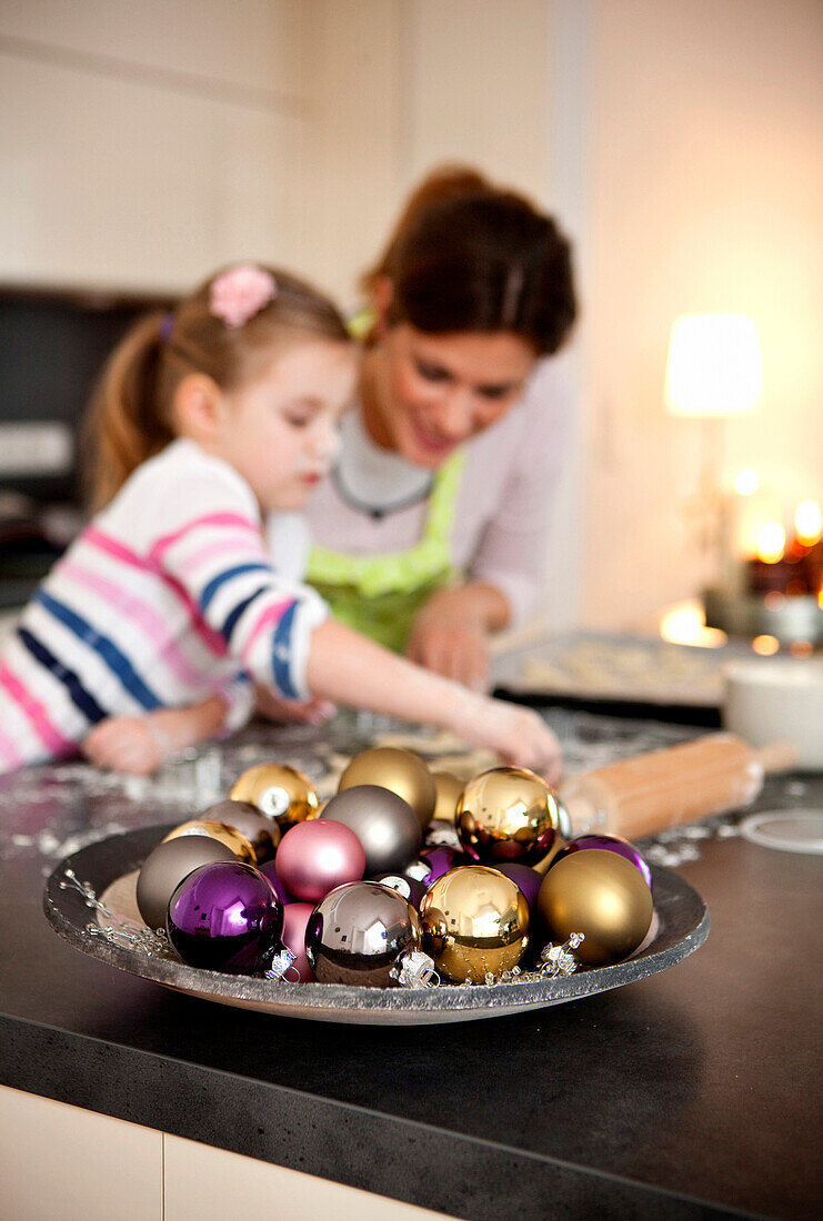 Mother and daughter (4 years) baking cookies