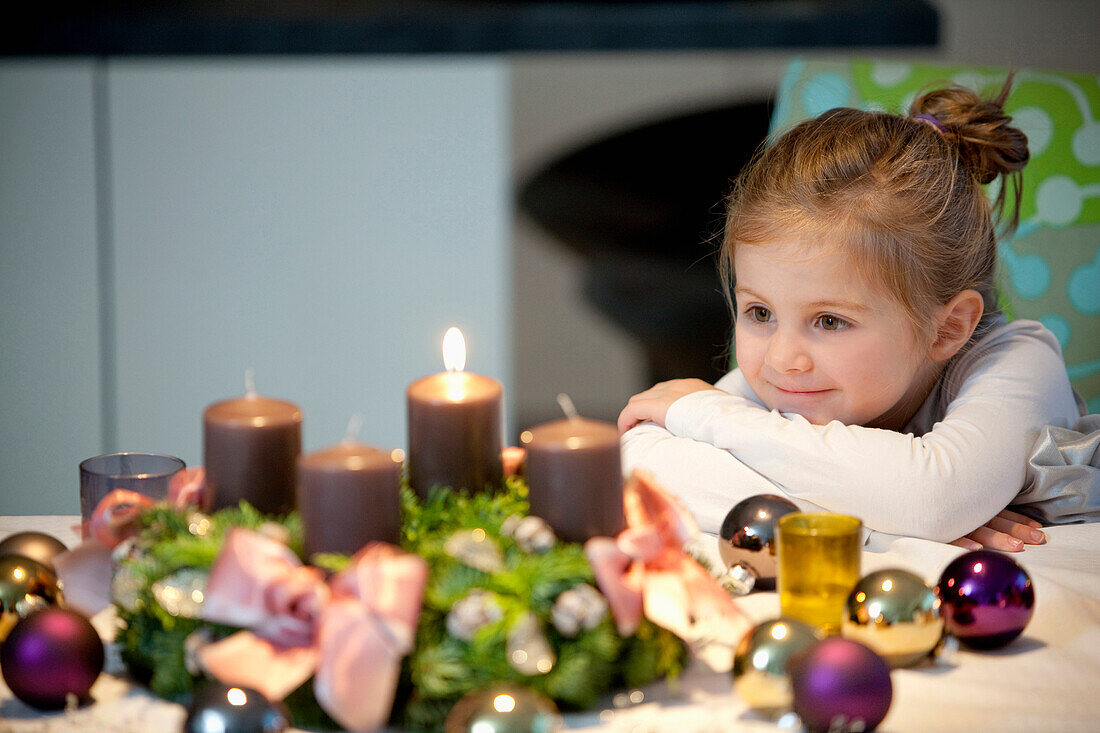 Girl  looking at an Advent wreath, Styria, Austria