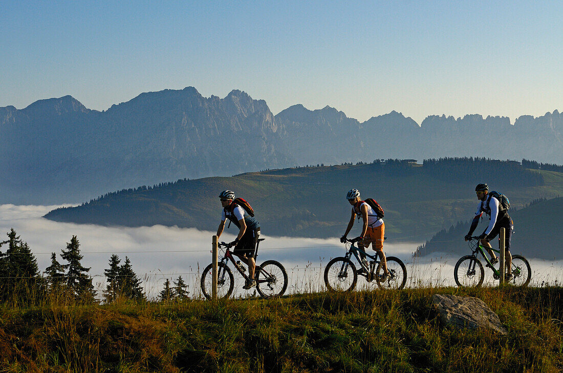 Mountain bikers at Lake Salvensee, Hohe Salve, Kitzbuehel Horn, Kitzbuehel Alps, Tyrol, Austria