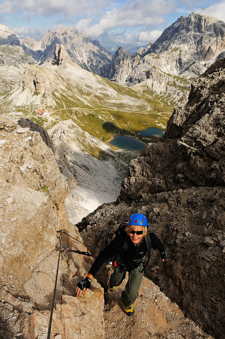 Teenager climbing on the Paternkofel fixed rope route, via ferrata, Boedenseen, Hochpustertal, Dolomites, South Tyrol, Italy