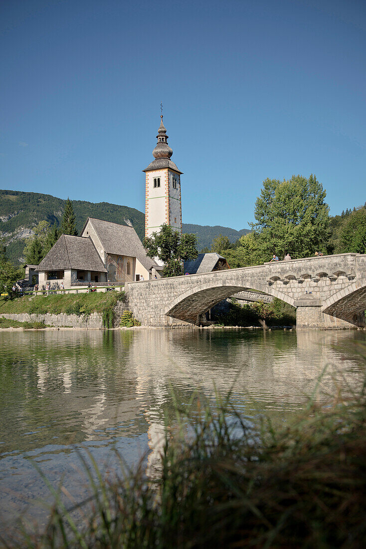 Medieval church of St John the Baptist at Lake Bohinj, stone bridge, Triglav National Park, Julian Alps, Gorenjska, Slovenia