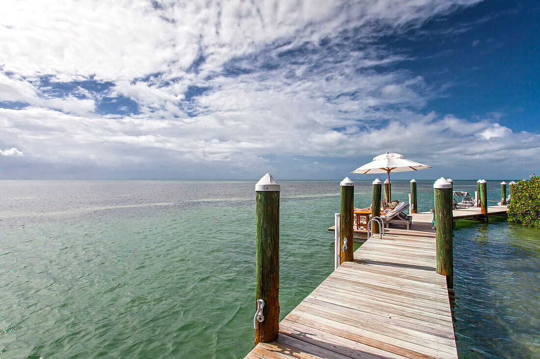Landing stage with tourists sunbathing, Little Palm Island Resort, Florida Keys, USA