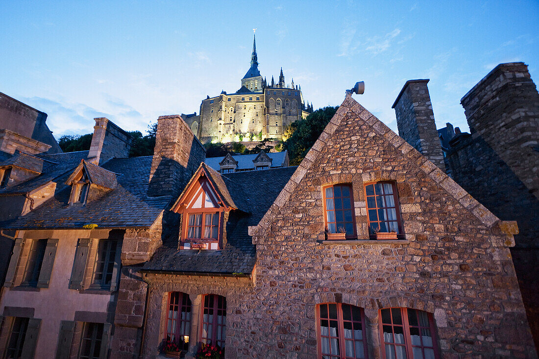 Houses in the fortified village and Abbey of Mont-Saint-Michel in the evening, France