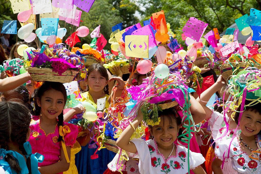 Girls carrying festive baskets in the Entrada de Comadritas parade during the Carnaval Chapaco, Tarija, Bolivia