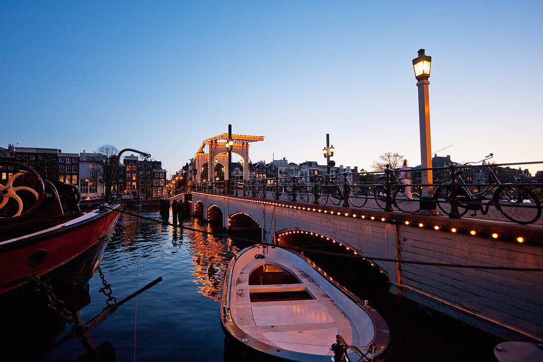 Magere Brug over the Amstel river at night, Amsterdam, Netherlands