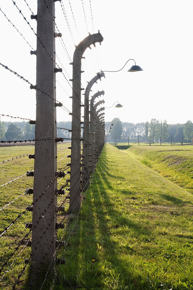 Electrified barbed wire fence separating sections of the Auschwitz-Birkenau Concentration Camp, Oswiecim, Malopolska, Poland