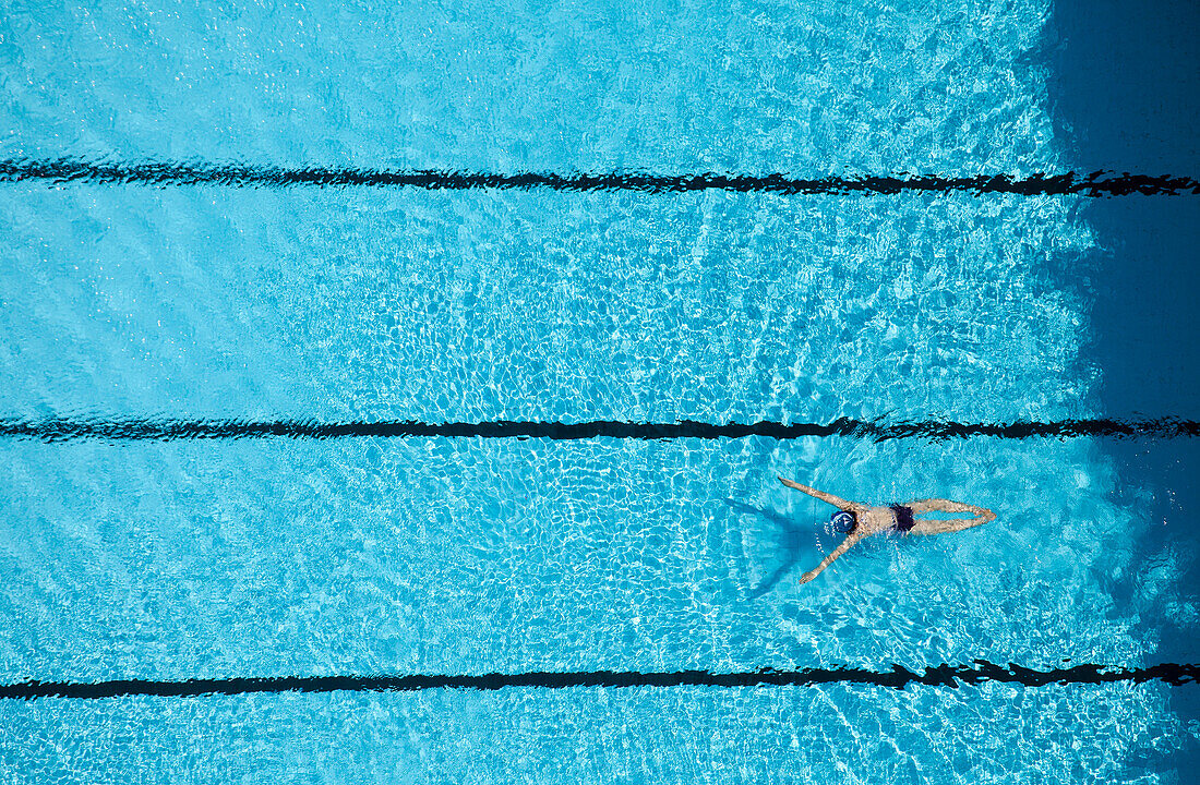 China, Guangzhou, Woman swimming in pool, View from above.