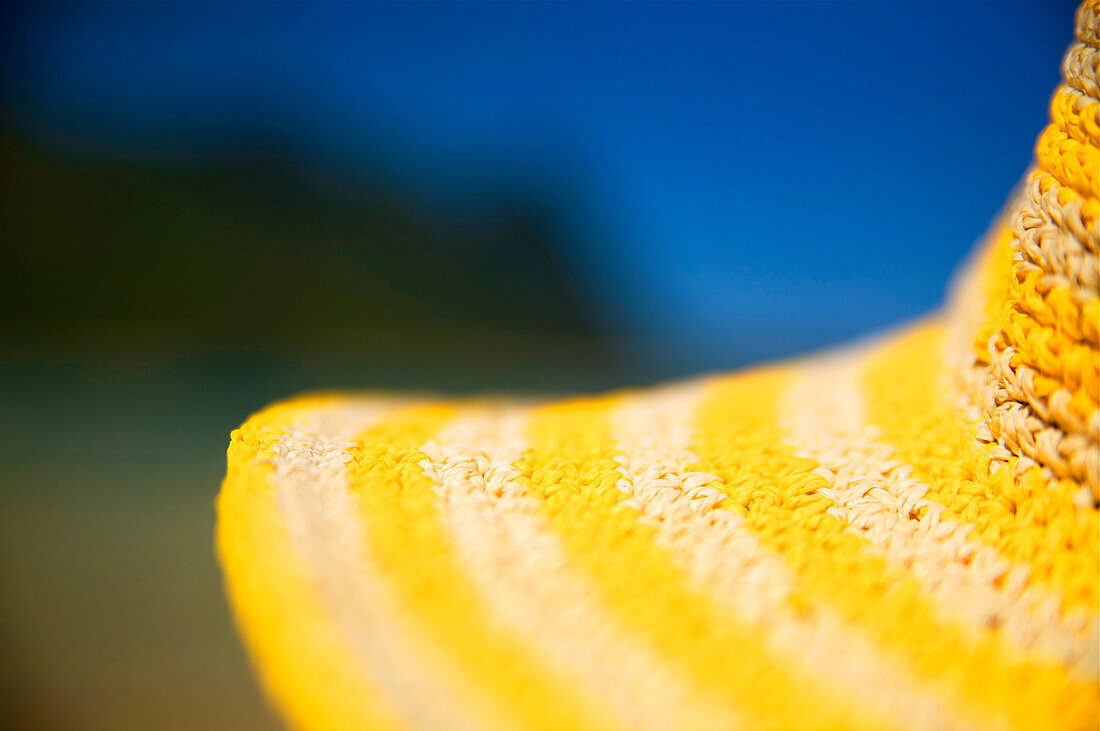 Hawaii, Kauai, Tunnels beach, close-up of a yellow straw hat on the beach.