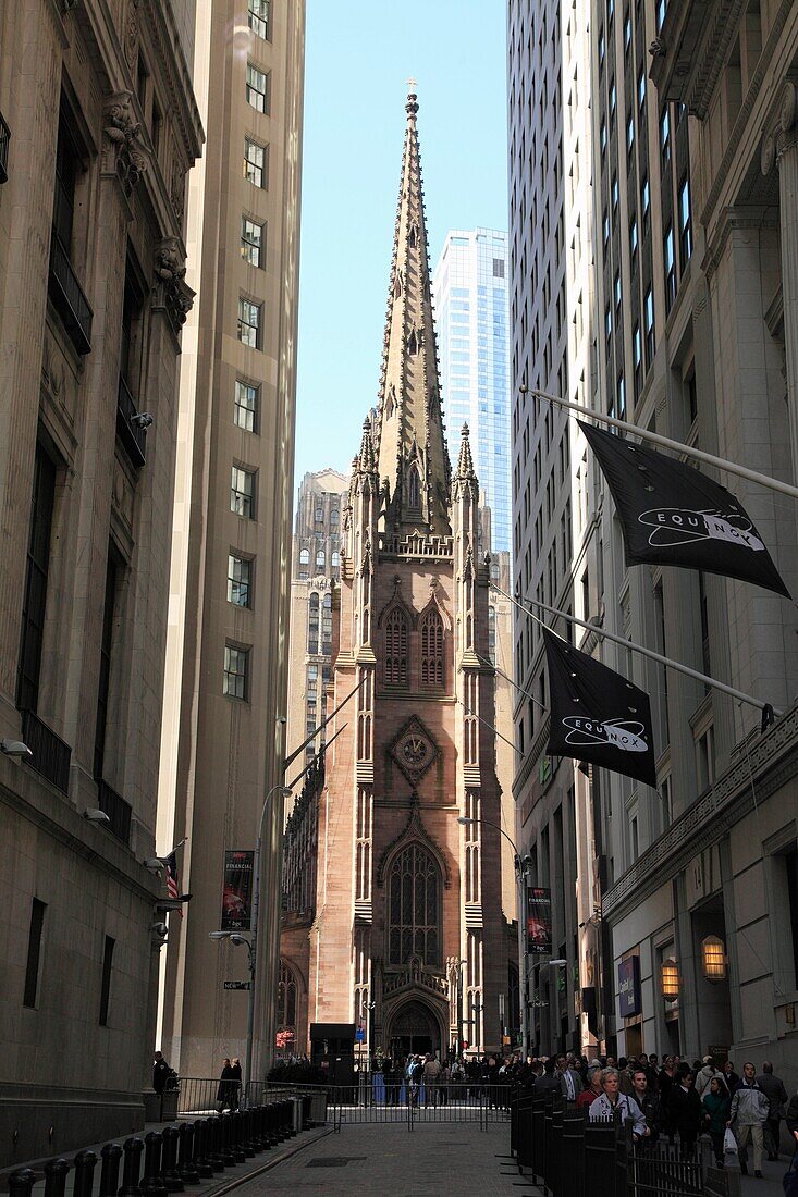 Wall Street with Trinity Church in the background  New York City  New York  USA.