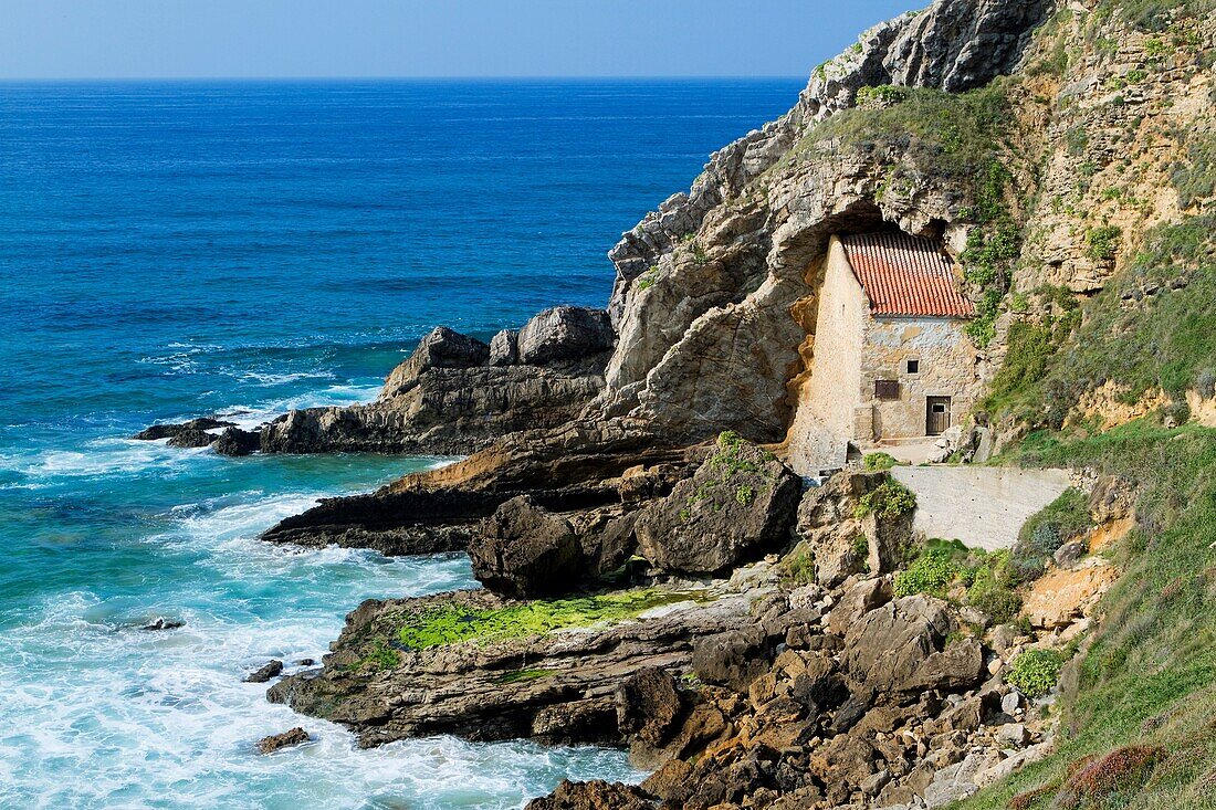 The small Santa Justa Chapel, embedded into the cliff  Santa Justa beach, Ubiarco village  Santillana del Mar  Cantabria  Spain