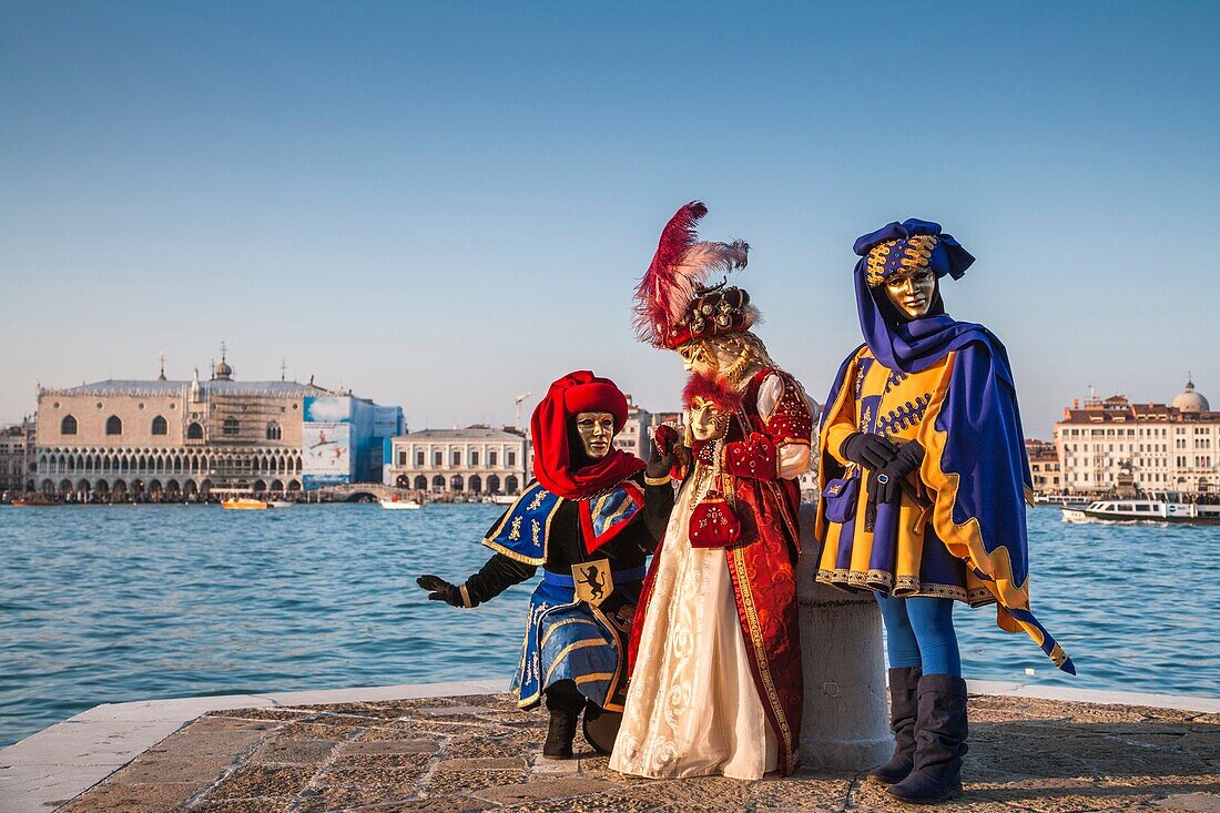 Three masked persons at the carnival in Venice, Italy, Europe