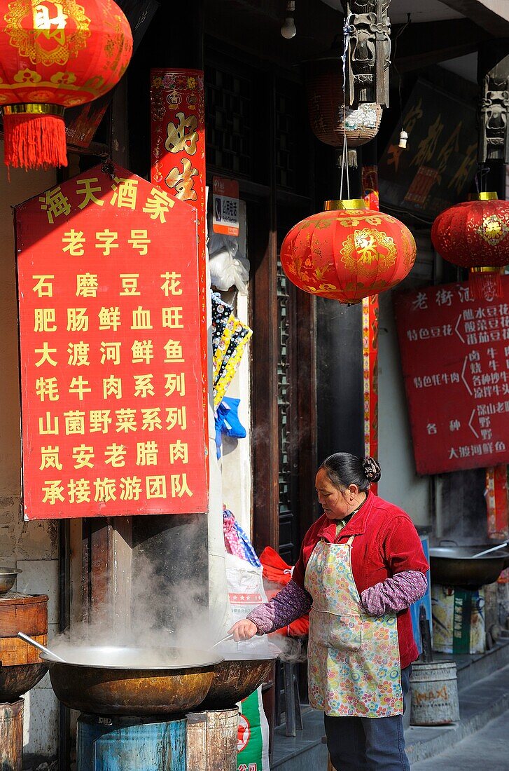 China, Sichuan, Luding, Street scene, Woman cooking food