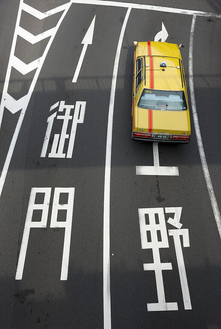 Aerial view of yellow Tokyo Taxi on a road in Tokyo Japan
