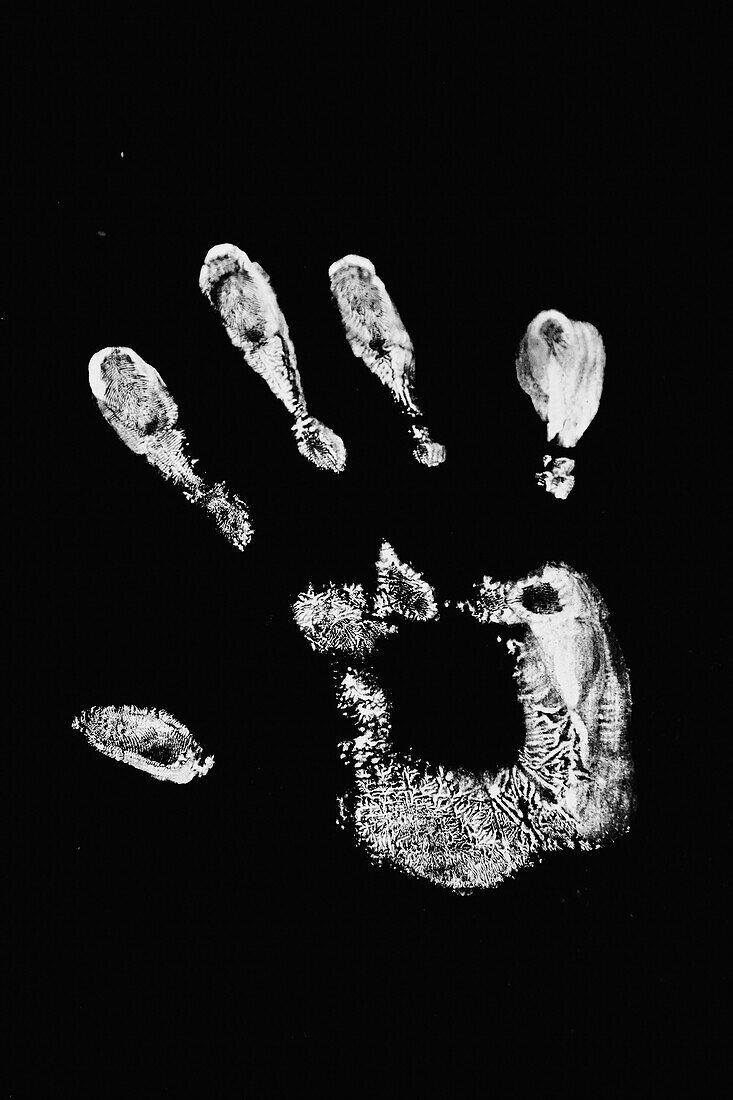 White hand print on black suface