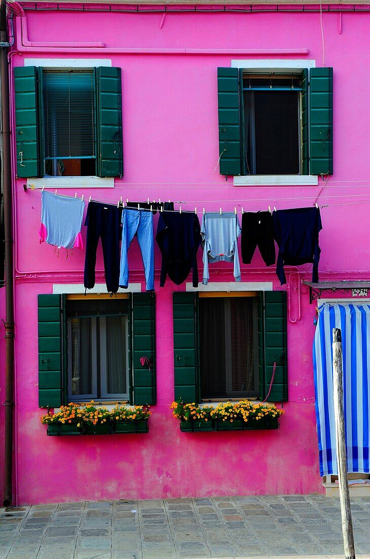 Colorful house with hanging laundry in the island of Burano near Venice,Italy,Europe