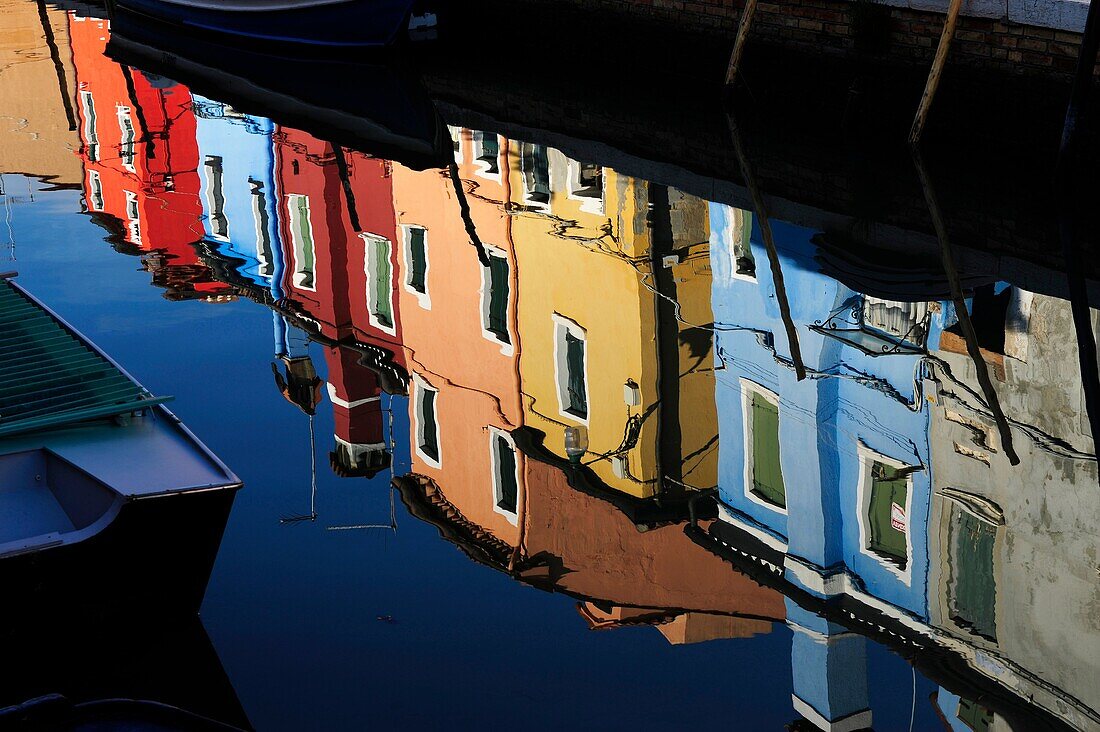 Colorful houses reflecting in Burano´s Grand Canal in the island of Burano near Venice,Italy,Europe
