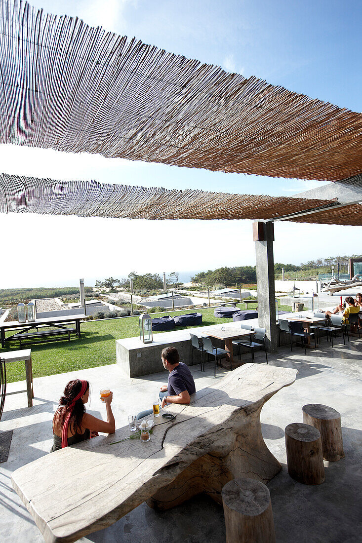 Guests on the driftwood furnished terrace, Hotel Areias do Seixo, Povoa de Penafirme, A-dos-Cunhados, Costa de Prata, Portugal