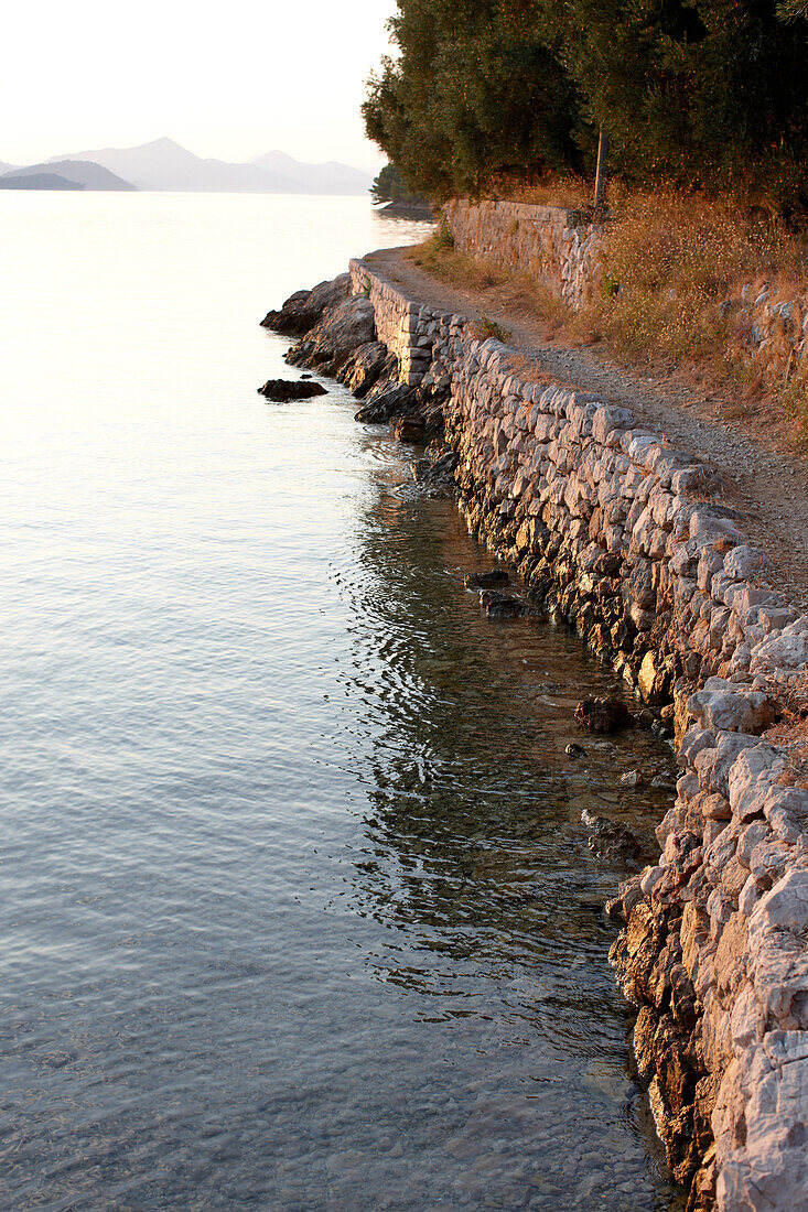 Path along the bay, Sipanska Luka, Sipan island, Elaphiti Islands, northwest of Dubrovnik, Croatia