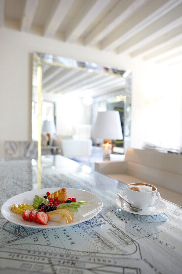 Coffee and fruits on a table designed as a venice city map, Grand Canal suite, Palazzina Grassi Hotel, Design Philippe Starck, Sestriere San Marco 3247, Venice, Italy
