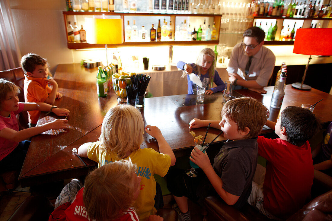 Children learning how to mix cocktails, children program in Hotel Haus Hirt, Bad Gastein, St. Johann im Pongau, Salzburg, Austria
