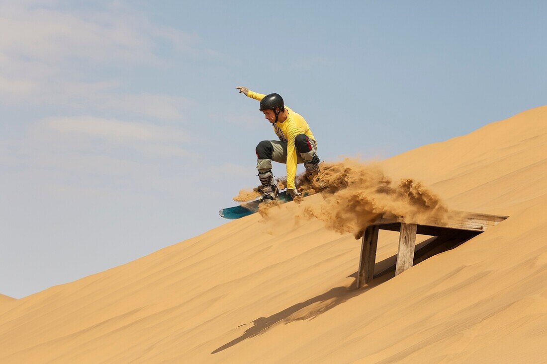 Sand boarding in the dunes of the Namib Desert near the coastal town of Swakopmund has become very popular  Swakopmund, Namibia