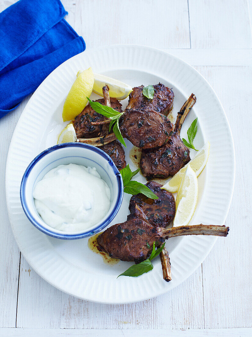 Plate of lamb mint and yogurt. Barbequed Lamb Cutlets _ Mint, Lemon, Yoghurt