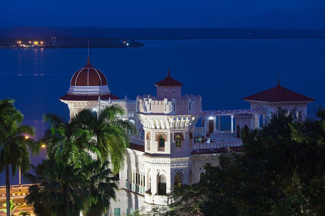 Cuba, Cienfuegos Province, Cienfuegos, Punta Gorda, Palacio de Valle, former sugar baron mansion, elevated view, dusk