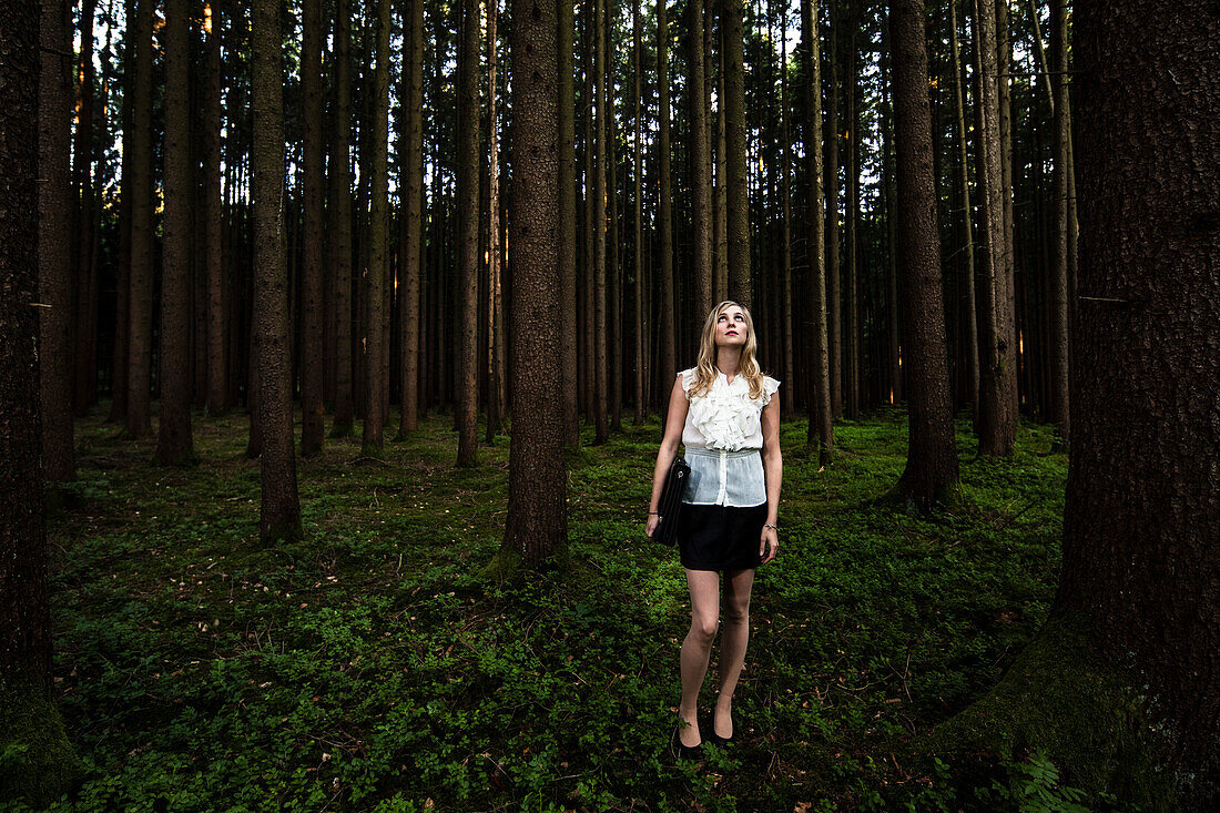 Young woman wearing business suit in a forest, Bavaria, Germany