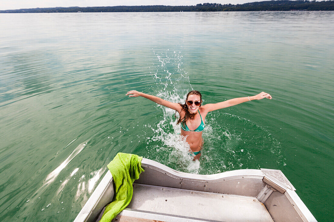 Young woman bathing in lake Starnberg, Bavaria, Germany